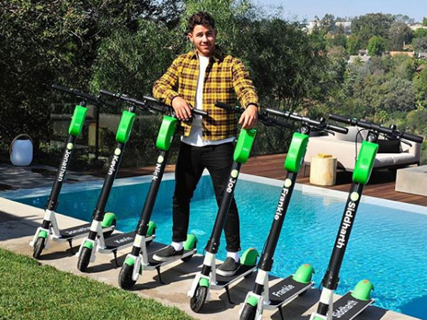 Nick Jonas Posing Alongside Custom Scooters