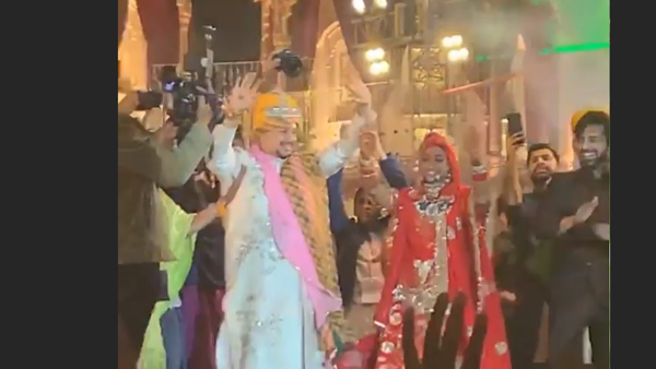 The Couple Wave To The Guests